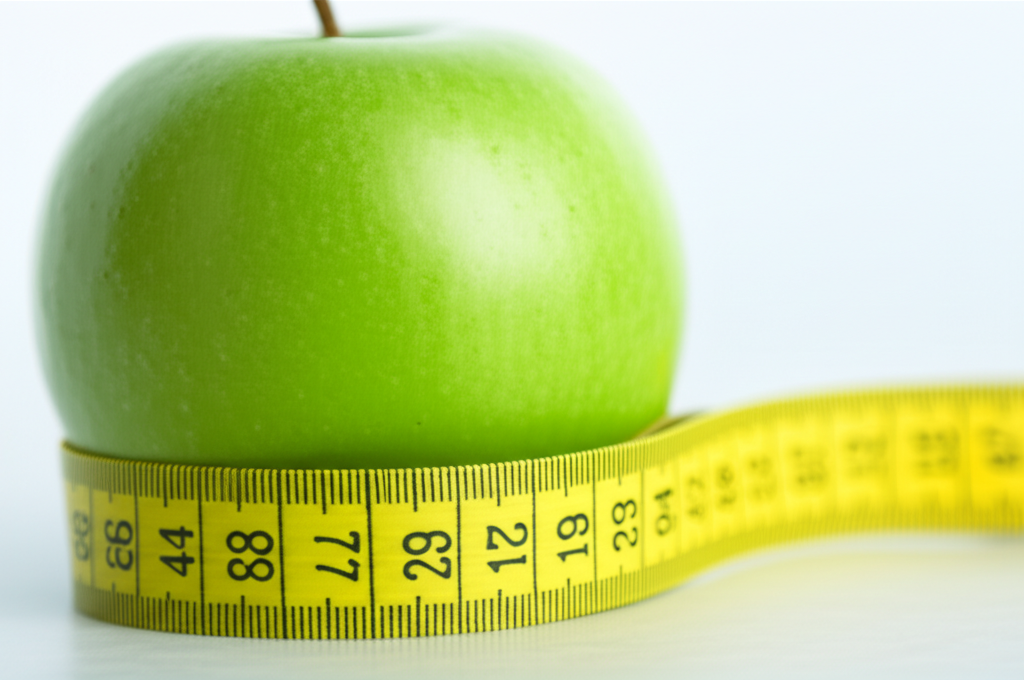 Nutriční terapie - jablko s měřicí páskou